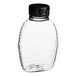 A clear plastic bottle with a black flip top lid.