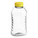 A clear plastic Ribbed Hourglass Honey Bottle with a yellow flip top lid.