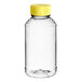A clear plastic bottle with a yellow cap containing honey.