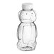 A clear plastic 16 oz. Bear PET honey bottle with a white flip top lid.