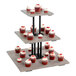 A Cal-Mil three tiered pine wood display riser with cupcakes on it.