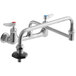 A T&S chrome wall mount pot/kettle filler with two double-jointed swing nozzles and two handles.