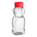 An 8 oz. clear PET bear honey bottle with a red cap.