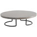 A round concrete table with a Cal-Mil black and gray pine display riser on top.