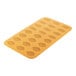 A yellow rectangular Silikomart silicone baking mold with a leaf pattern.