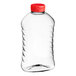 A 22 oz. clear ribbed PET honey bottle with a red cap.