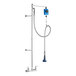 A T&S wall mount pre-rinse unit with a hose and blue and silver spray nozzle.