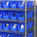 Regency blue plastic bins on metal shelving.