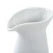 An Arcoroc white creamer with a curved neck.