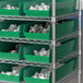 A shelf with Regency green shelf bins.