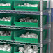 A Regency shelf with green storage bins.