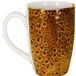 A brown porcelain RAK mug with a pattern on it.