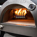 A Pinnacolo L'Argilla gas-powered pizza oven with flames inside.