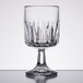A close-up of a Libbey Winchester wine glass with a curved stem and diamond pattern.