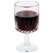 A Libbey Winchester wine glass filled with red wine on a table.