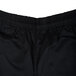 A close up of black Chef Revival baggy chef pants with a white logo on the side.
