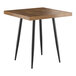 A Lancaster Table & Seating square wooden table with black legs.