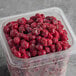 A plastic container of IQF Organic Pitted Red Tart Cherries.