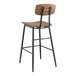 A Lancaster Table & Seating black metal barstool with wood seat and backrest.