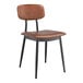 A Lancaster Table & Seating Mid-Century black chair with cognac vinyl padded seat and backrest.