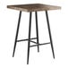 A Lancaster Table & Seating bar height table with black legs and a square wooden top.