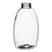 A clear plastic Classic Queenline honey bottle with a black lid.
