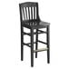 A black wood Lancaster Table & Seating School House bar stool.