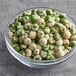 A bowl of green wasabi peas.
