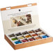 A box of Nespresso Professional single serve coffee capsules with a variety of colors inside.