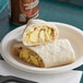 A Green Chile Food Fiesta Breakfast Burrito on a plate.