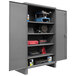 A large metal Durham Mfg storage cabinet with tools on shelves.
