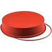A red round Silikomart silicone baking mold with a lid.