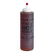 A close up of a Mike's Hot Honey Extra Hot chef bottle with a white cap.