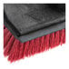 A red and black Lavex floor scrub brush with a red metal handle.