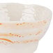 A white bowl with an orange and brown wave pattern.
