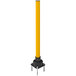 A yellow Impact Recovery Systems SlowStop rebounding steel bollard.
