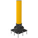 A yellow Impact Recovery Systems SlowStop steel bollard with a black base.