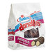 A plastic bag of Hostess Chocolate Frosted Mini Donettes with a white edge.