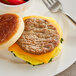 A breakfast sandwich with a sausage patty on a bun.