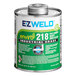 A white and green open can of E-Z Weld Clear Heavy Body PVC Cement.