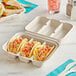 World Centric compostable 3-compartment taco clamshell with tacos inside.