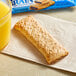 A Nutri-Grain Blueberry cereal bar on a napkin next to a glass of orange juice.
