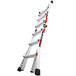 A Little Giant aluminum articulated extendable ladder with red handles.