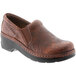 A pair of women's brown leather Klogs Naples clogs with a black sole.