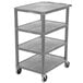 A grey plastic Luxor serving cart with four shelves on wheels.
