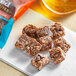 A bag of Bear Naked Dark Chocolate and Sea Salt Granola Bites on a table with other snacks.