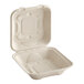 A white World Centric compostable fiber clamshell with a lid.