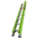 A green Little Giant fiberglass extension ladder with silver bars and black handles.
