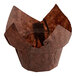 A Baker's Mark brown paper muffin wrapper with a brown paper bag.