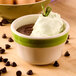 A close-up of a CAC stoneware bouillon bowl filled with chocolate pudding topped with whipped cream and chocolate chips.